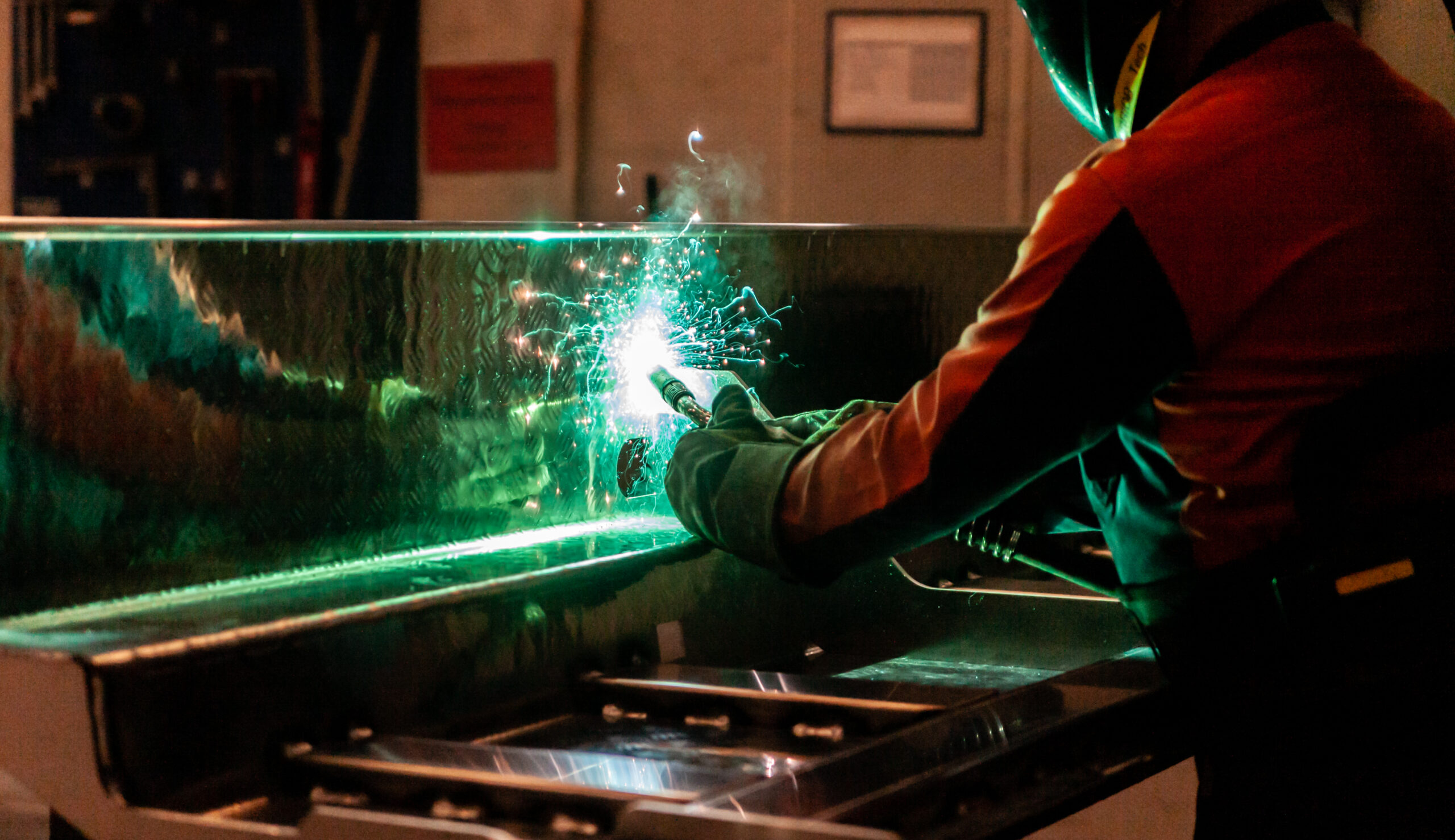 welder in production hall welding steel